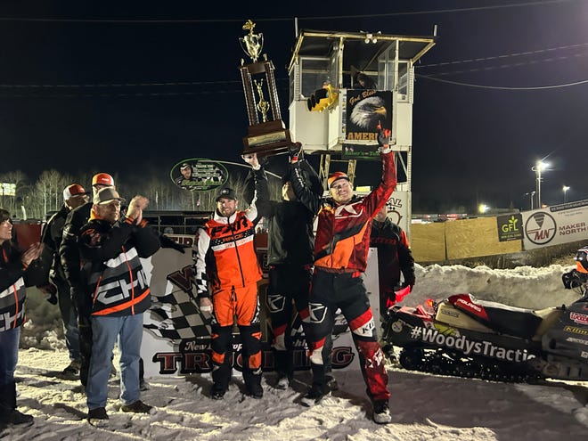 The Bunke Racing team holds its I-500 trophy.